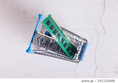 Close up of two computer memory modules in a shopping cart on a table top view 141110886