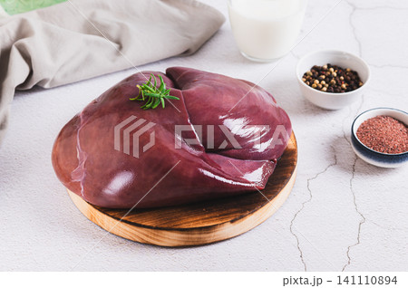 Fresh beef liver on a cutting board on the table 141110894
