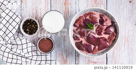 A bowl of raw chopped liver marinated in milk on the table top view web banner A bowl of raw chopped liver marinated in milk on the table top view web banner 141110919