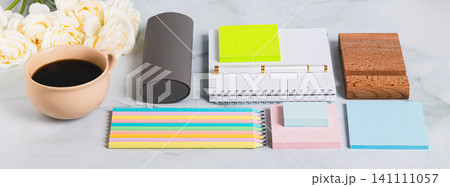 A notebook, pen, cup of coffee and stationery on a desk web banner 141111057