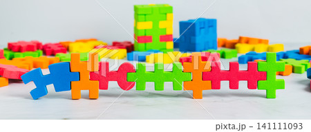 Colorful puzzle pieces for children's tabletop game web banner Colorful puzzle pieces for children's tabletop game web banner 141111093