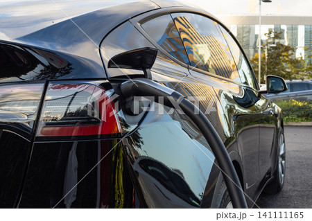 Electric vehicle charging at a public station Electric vehicle charging at a public station 141111165