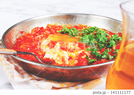 traditional Turkish dish, scrambled eggs with tomatoes, Menemen, with herbs, in a frying pan, close-up, no people, 141111177