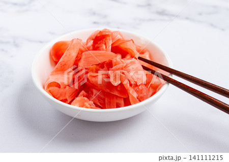 Pickled ginger, with chopsticks, in a small white bowl, on a marble countertop, close-up, no people, Pickled ginger, with chopsticks, in a small white bowl, on a marble countertop, close-up, no people, 141111215