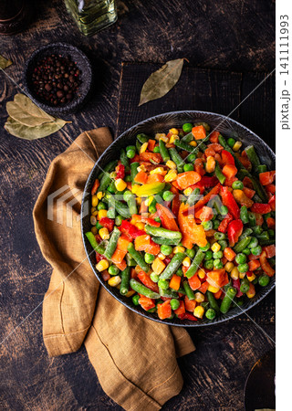 Frozen mix of vegetables on dark background Frozen mix of vegetables on dark background 141111993