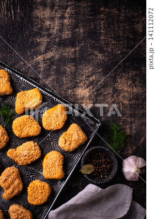 Raw uncooked frozen chicken nuggets Raw uncooked frozen chicken nuggets 141112072