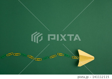 Paper plane leading a chain of paper clips Paper plane leading a chain of paper clips 141112115