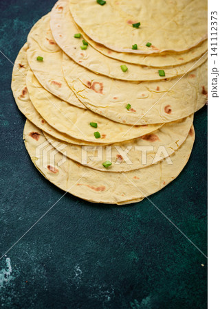 Lavash flat bread on green background Lavash flat bread on green background 141112373