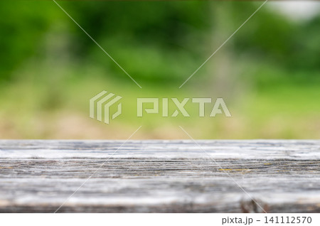 Empty wooden surface with blurred green park background and copy space Empty wooden surface with blurred green park background and copy space 141112570