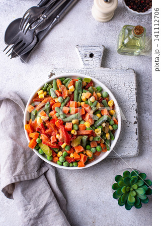 Frozen mix of vegetables on dark background Frozen mix of vegetables on dark background 141112706