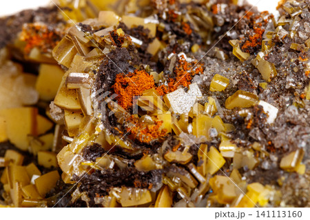 Macro mineral stone yellow Wulfenite on a white background Macro mineral stone yellow Wulfenite on a white background 141113160