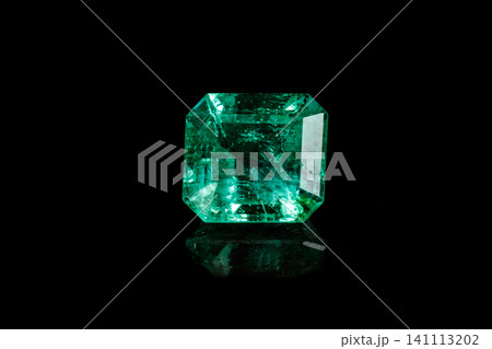 Macro mineral Emerald gemstone faceted on black background Macro mineral Emerald gemstone faceted on black background 141113202