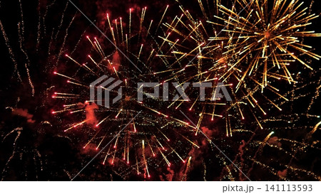 Vivid fireworks exploding across dark night sky with golden starbursts, red spark trails, glowing smoke clouds, layered bursts, dramatic contrast, radiant festive energy Vivid fireworks exploding across dark night sky with golden starbursts, red spark trails, glowing smoke clouds, layered bursts, dramatic contrast, radiant festive energy 141113593
