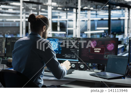 Server room computer scientist trying to fix system faults working with AI program. Server room computer scientist trying to fix system faults working with AI program. 141113946