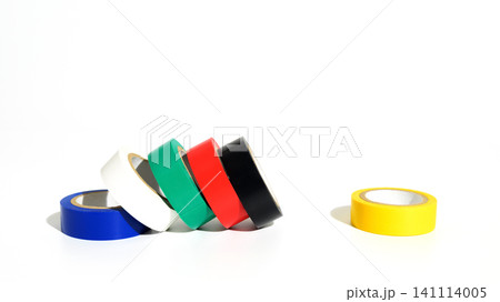 several multicolored rolls of adhesive tape leaning on each other and a yellow roll laying separate several multicolored rolls of adhesive tape leaning on each other and a yellow roll laying separate 141114005