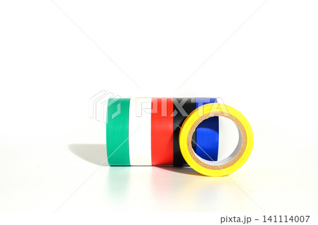yellow roll of insulating tape standing in the foreground in front of joined colorful spools yellow roll of insulating tape standing in the foreground in front of joined colorful spools 141114007