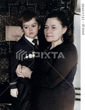 Grandmother Holding a Young Boy in Soviet Military Style Uniform in Dnipropetrovsk, Ukraine, September 1971 Grandmother Holding a Young Boy in Soviet Military Style Uniform in Dnipropetrovsk, Ukraine, September 1971 141114489