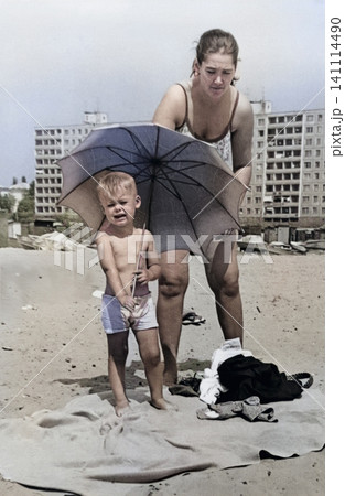 Mother Unpacking Beach Belongings with Her Young Son in Dnipropetrovsk, Ukraine, May 1970 Mother Unpacking Beach Belongings with Her Young Son in Dnipropetrovsk, Ukraine, May 1970 141114490