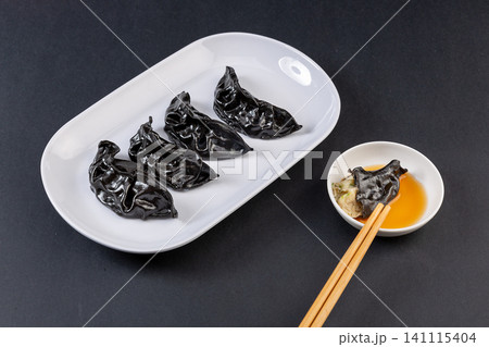 black Cuttlefish Ink Steamed Dumplings in Bamboo Basket, Seafood Dim Sum black Cuttlefish Ink Steamed Dumplings in Bamboo Basket, Seafood Dim Sum 141115404