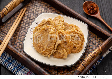 deep-fried stuffed lotus root slices on a white plate, traditional hot pot ingredients 141116085