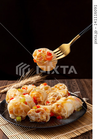 refreshing cold wheat gluten salad with garlic and chili sauce on a dark wooden table refreshing cold wheat gluten salad with garlic and chili sauce on a dark wooden table 141116091