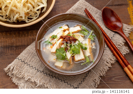 traditional Henan Luoyang tofu soup with fried tofu and green onions in a ceramic pot 141116141