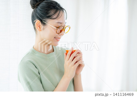 トマトジュースを飲む若い女性 141116469