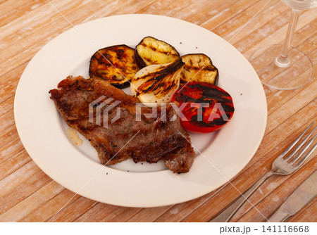 Grilled beef steak with grilled eggplant, onion and tomatoes 141116668