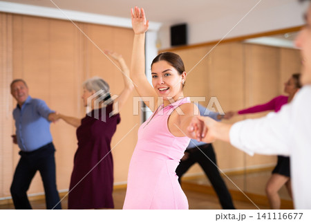 Cheerful female dancer practicing ballroom dances in ballroom 141116677