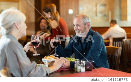 Mature couple communicate and chatting during date in cafe Mature couple communicate and chatting during date in cafe 141116778