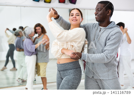 Girl learning to dance waltz paired with african american man 141116789
