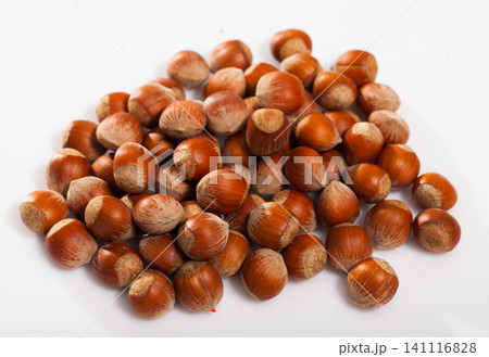 Pile of filberts on white surface Pile of filberts on white surface 141116828
