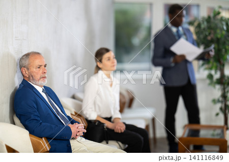 Eldery man sitting in job interview queue in office Eldery man sitting in job interview queue in office 141116849