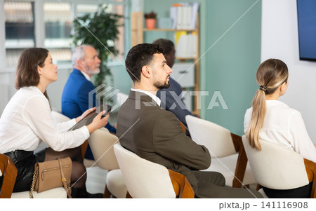 Male businessman courses visitor at meeting listens to teacher and look at speaker 141116908