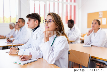 Young woman medical student attending lecture in university Young woman medical student attending lecture in university 141117149