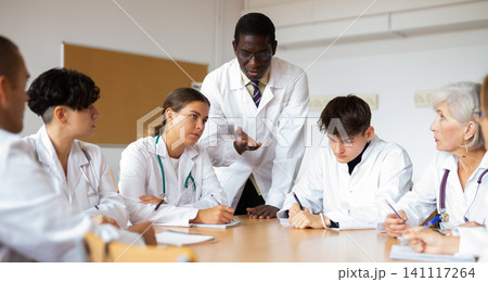 Professor explaining subject to group of medical students 141117264