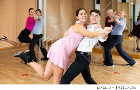 Young pair practicing ballroom dance in dance studio Young pair practicing ballroom dance in dance studio 141117355
