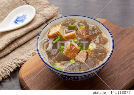 traditional Chinese sweet potato starch jelly soup with tofu cubes and green onions in a ceramic bowl traditional Chinese sweet potato starch jelly soup with tofu cubes and green onions in a ceramic bowl 141118077