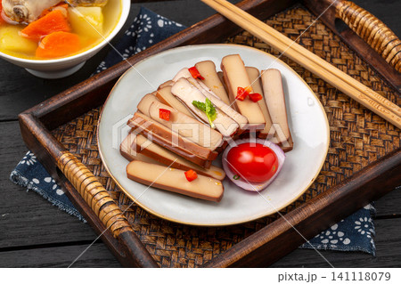 traditional Chinese spiced firm tofu salad with chili and tomato on a rustic wooden tray, authentic Asian appetizers. 141118079