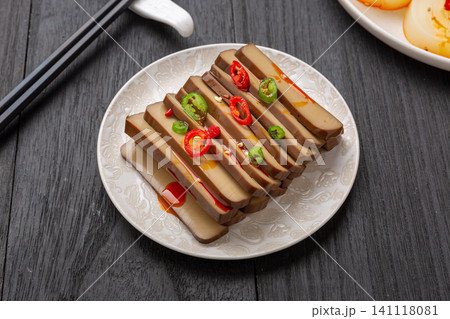 traditional Chinese spiced firm tofu salad with chili and tomato on a rustic wooden tray, authentic Asian appetizers. 141118081