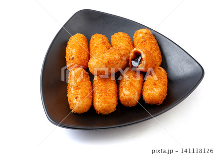 stack of crispy fried glutinous rice cakes with oozing black brown sugar filling in a plate stack of crispy fried glutinous rice cakes with oozing black brown sugar filling in a plate 141118126