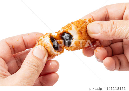 macro shot of crispy fried glutinous rice cakes with molten brown sugar syrup bursting inside, isolated on white background macro shot of crispy fried glutinous rice cakes with molten brown sugar syrup bursting inside, isolated on white background 141118131
