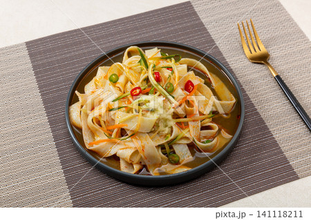 chinese cold starch noodles salad served with side dipping sauces of garlic and chili oil chinese cold starch noodles salad served with side dipping sauces of garlic and chili oil 141118211