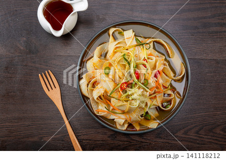chinese cold starch noodles salad served with side dipping sauces of garlic and chili oil chinese cold starch noodles salad served with side dipping sauces of garlic and chili oil 141118212