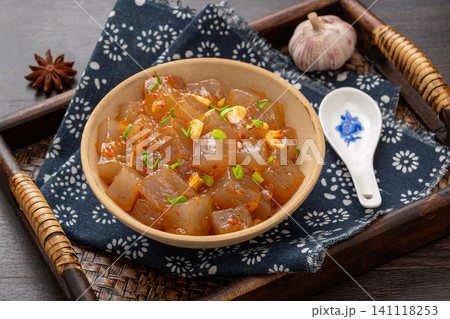 stir-fried sweet potato starch jelly with spicy chili sauce and chopped garlic in a bowl stir-fried sweet potato starch jelly with spicy chili sauce and chopped garlic in a bowl 141118253