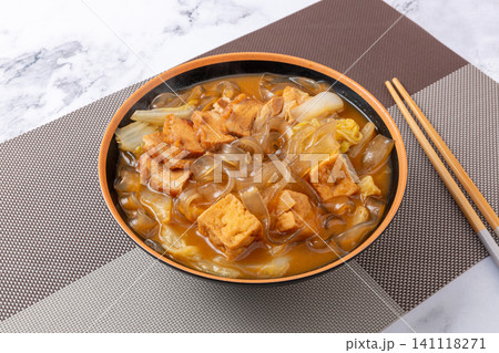 braised flat sweet potato glass noodles with fried tofu and cabbage in a ceramic bowl braised flat sweet potato glass noodles with fried tofu and cabbage in a ceramic bowl 141118271