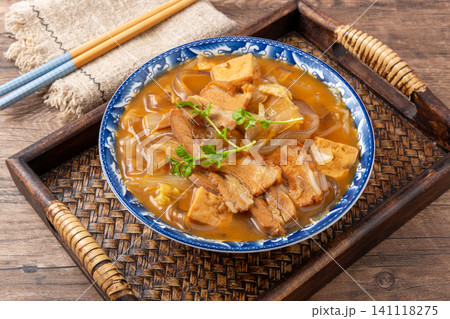 henan Anyang style flat glass noodles stewed with pork belly and tofu in a blue floral bowl 141118275