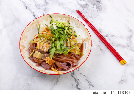 tri-color healthy mixed Liangpi cold noodles salad with cucumber and red chopsticks on a marble background tri-color healthy mixed Liangpi cold noodles salad with cucumber and red chopsticks on a marble background 141118308
