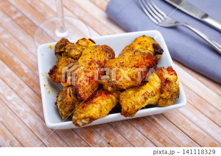 Plate of tasty snack - roasted chicken wings 141118329