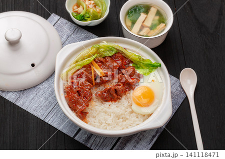 Chinese claypot rice with tender beef, fried egg and bok choy vegetables in ceramic pot Chinese claypot rice with tender beef, fried egg and bok choy vegetables in ceramic pot 141118471